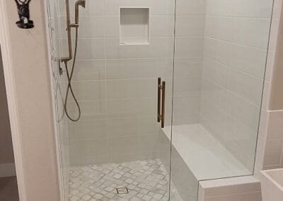 Modern shower remodel featuring high quality tile and elegant shower head