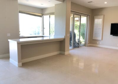 Home remodel featuring lavish open space, white square tile and stone countertops.