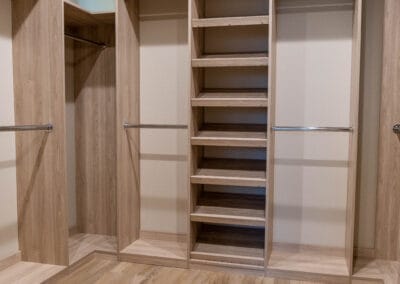 Custom light wood closet set and flooring featuring modern design and boutique style