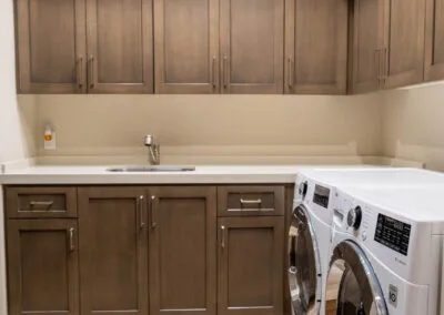 Beautiful custom and modern wooden cabinets in laundry room