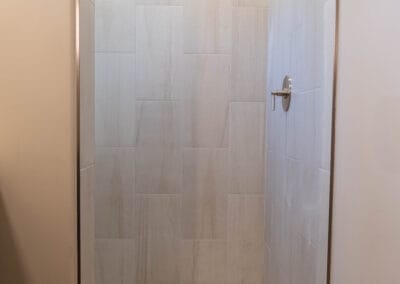 Custom tile shower featured in home remodel with open design