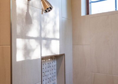 white stone tile featured in custom shower for modern home remodel