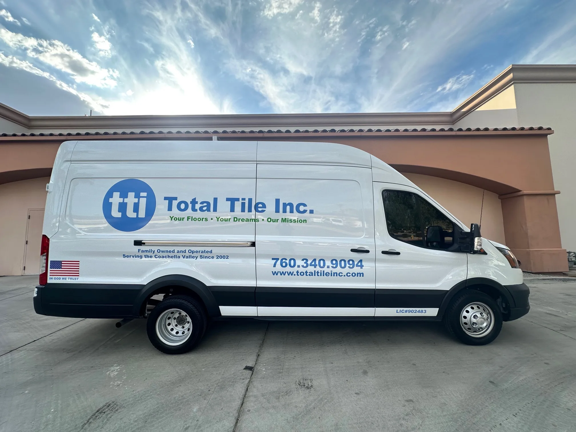 total-tile-inc-work-van Total Tile Inc. van parked and displaying standard blue logo with contact information.